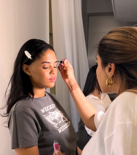Make-up being applied to a model on set