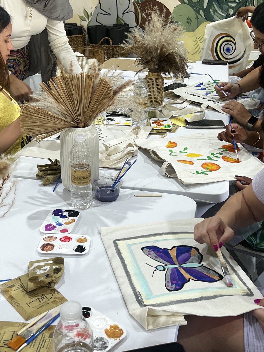 Painted tote bags at the workshop table