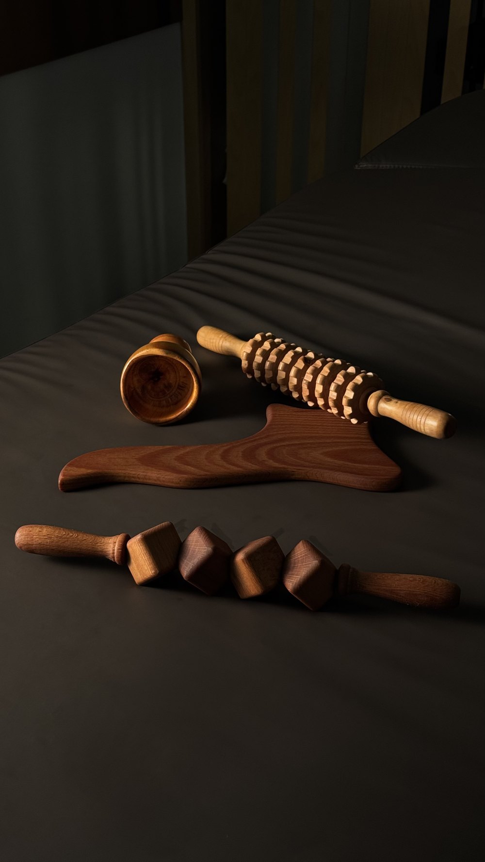 Wooden massage tools on black fabric