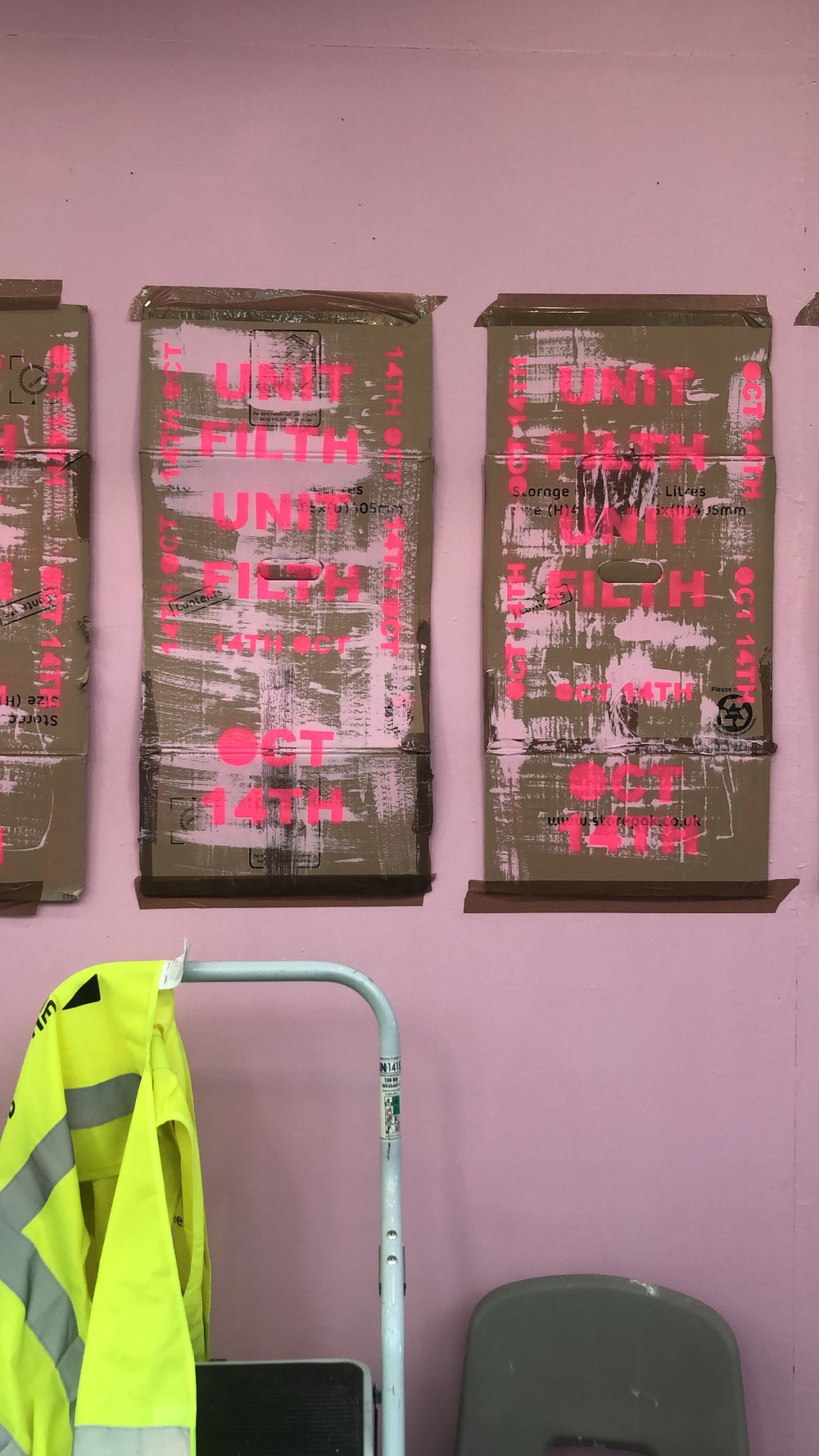 Unit Filth posters spray-painted on cardboard